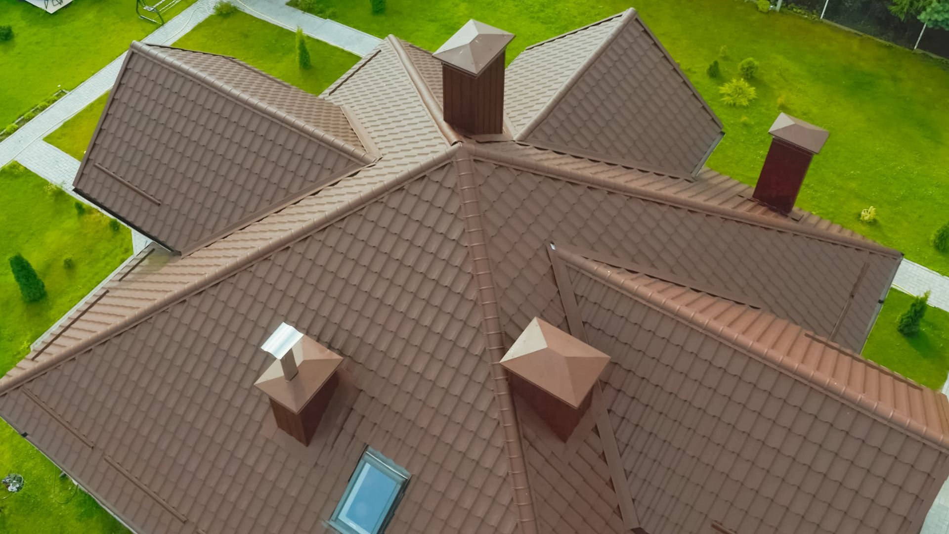 Aerial view of a complex roof with multiple angles and brown tiles