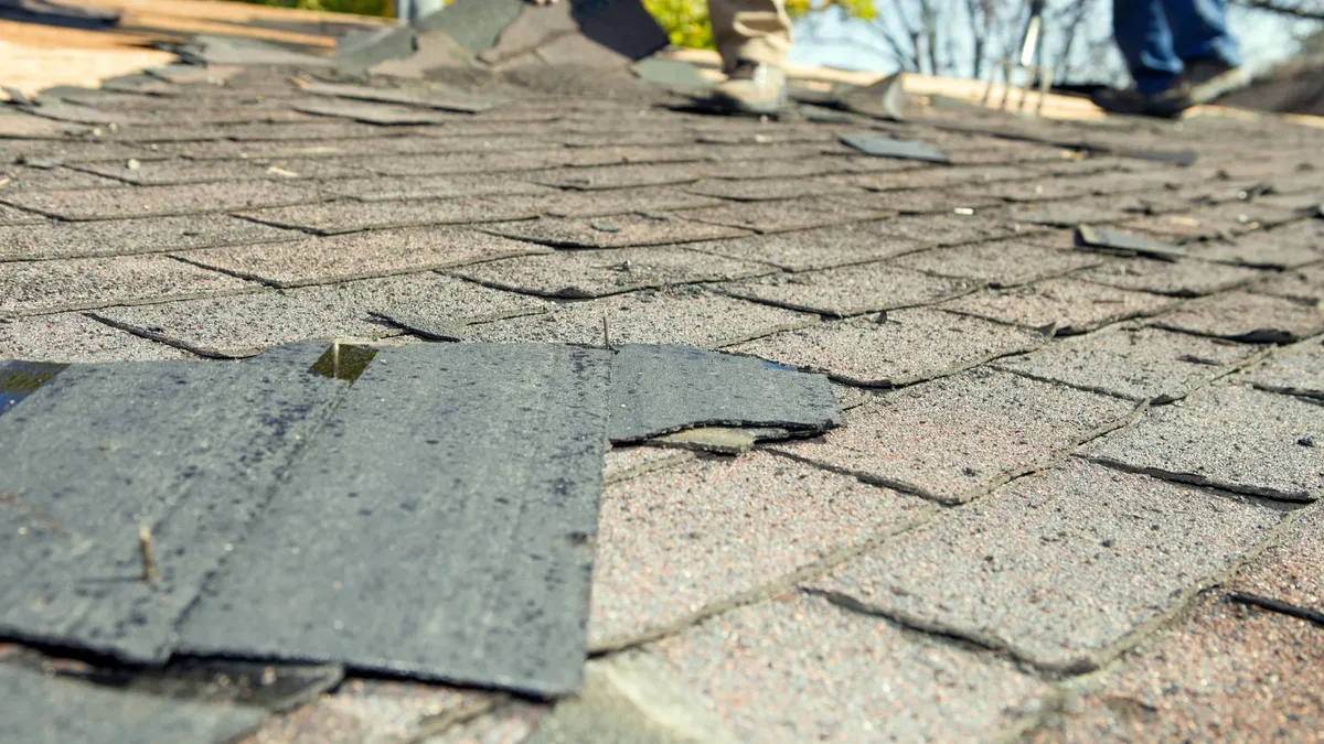 Roof repair fixing damaged shingles